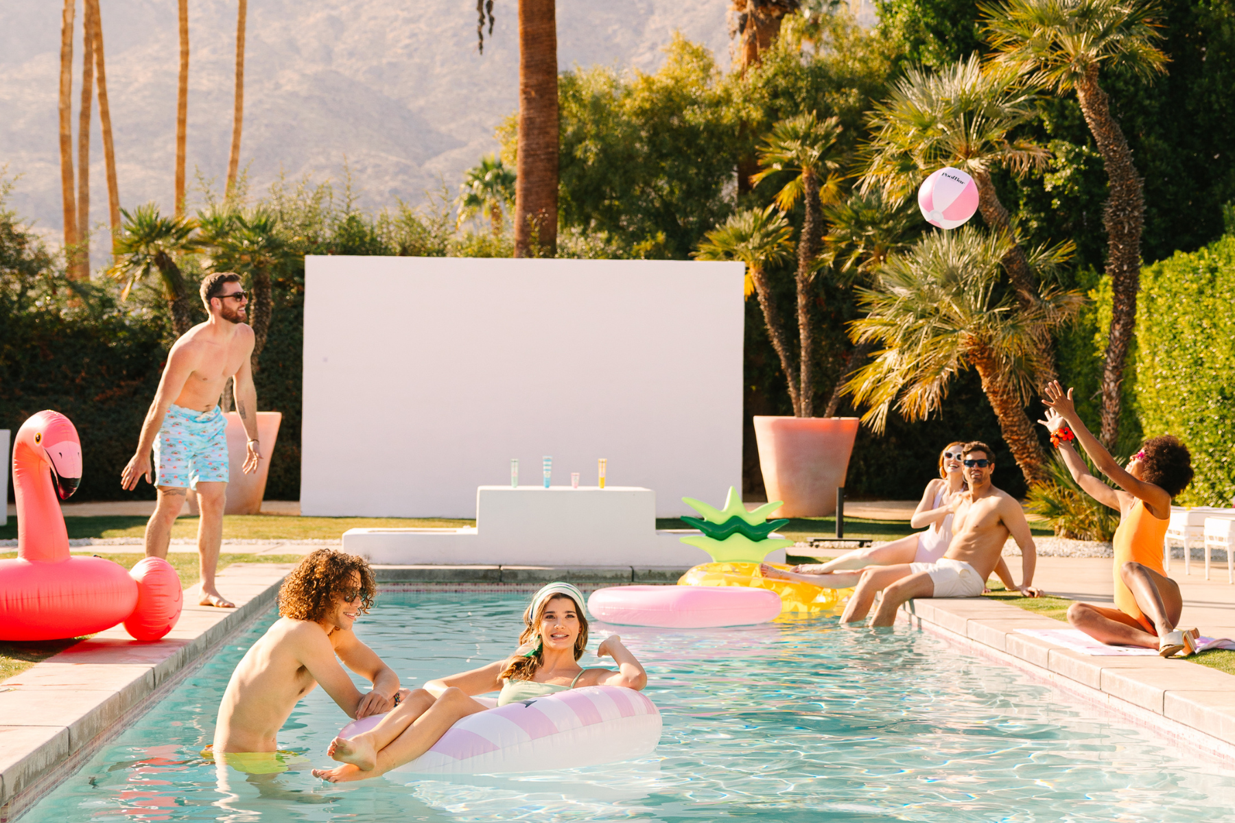 Group of people playing around a pool