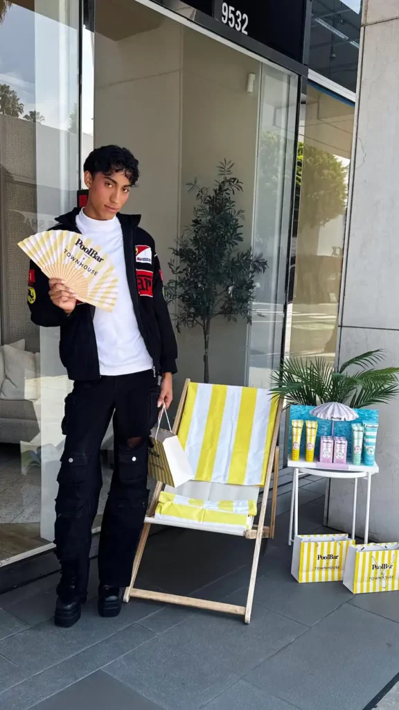 holding a fan at poolbar x townhouse event