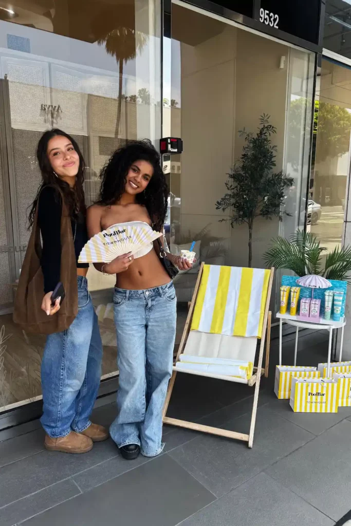 two girls posing with poolbar merch townhouse
